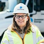 Female employee in hardhat and safety vest