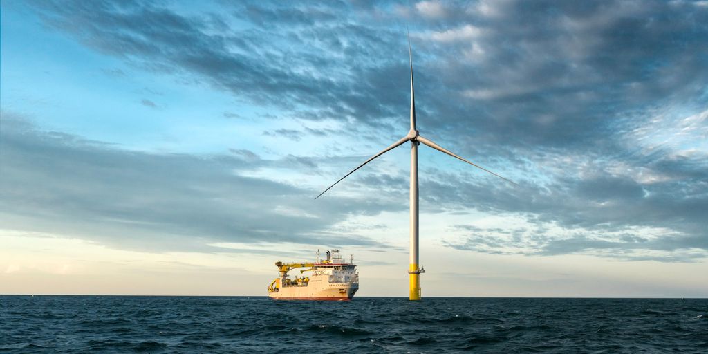 Offshore wind turbine with ship in the background