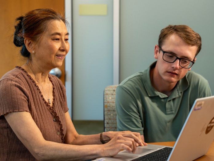 Jo Xin, senior business performance analyst and colleague in a meeting